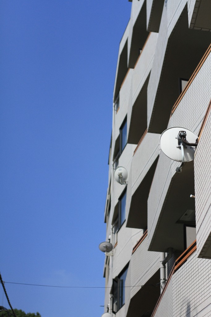 Architecture — apartment facade and blue sky, low angle