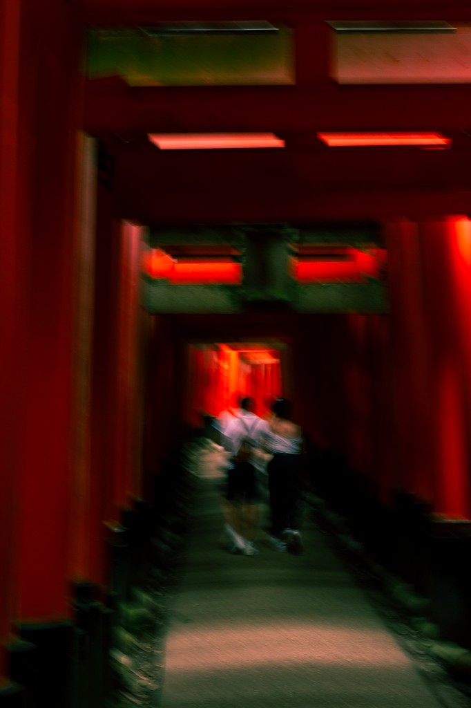 Travel — motion blur through vermilion torii gates