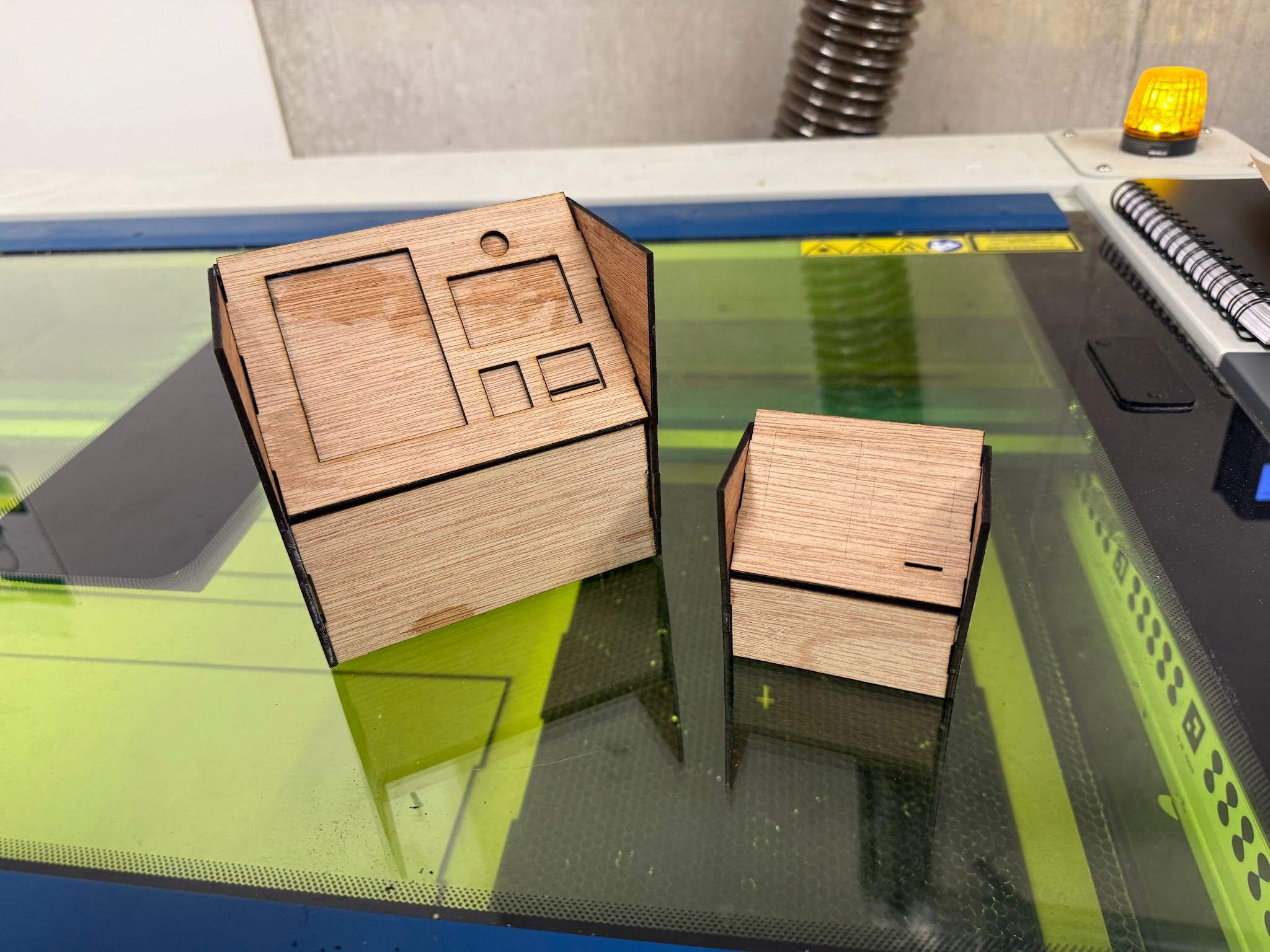 Two refined laser-cut ReliefHub kiosk form studies